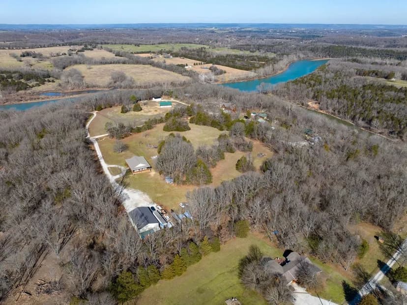 Amazing custom Table Rock Lake lakeside home at Kings River with an additional one bed one bath in the shop and 10 +/-  acres