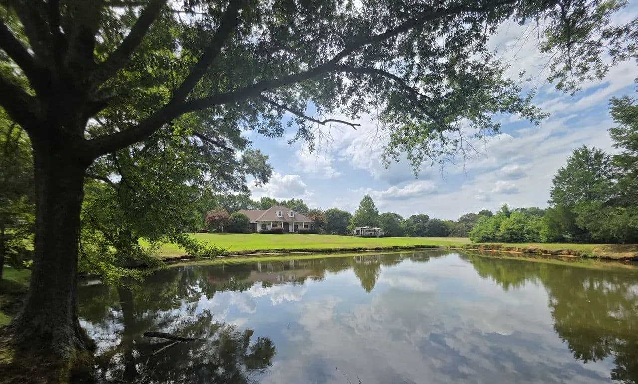 Private 21.5-Acre Estate with Pool, Stocked Pond and Shop — $525,000 - land for sale