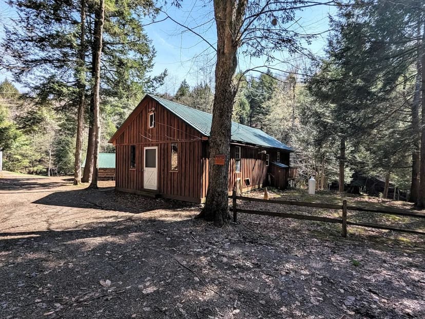 105 acres Furnished Cabin, Barn, Pond and Stream bordering State Land in Ossian NY Frost Rd